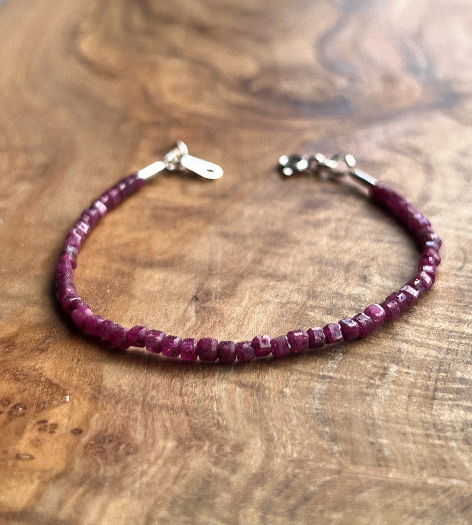 Pinkish red ruby gemstone with sterling silver bracelet