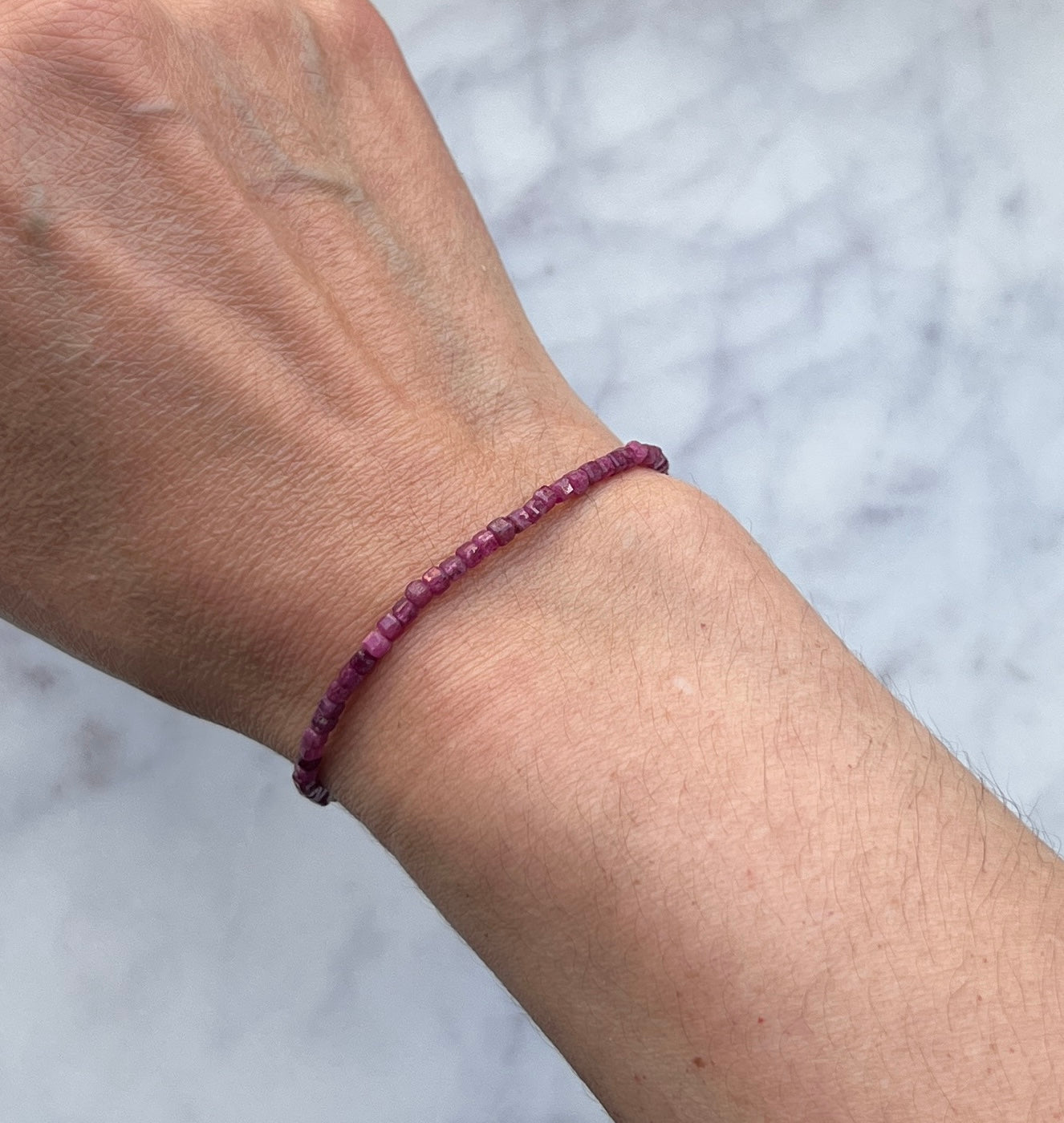 Pinkish red ruby gemstone with sterling silver bracelet