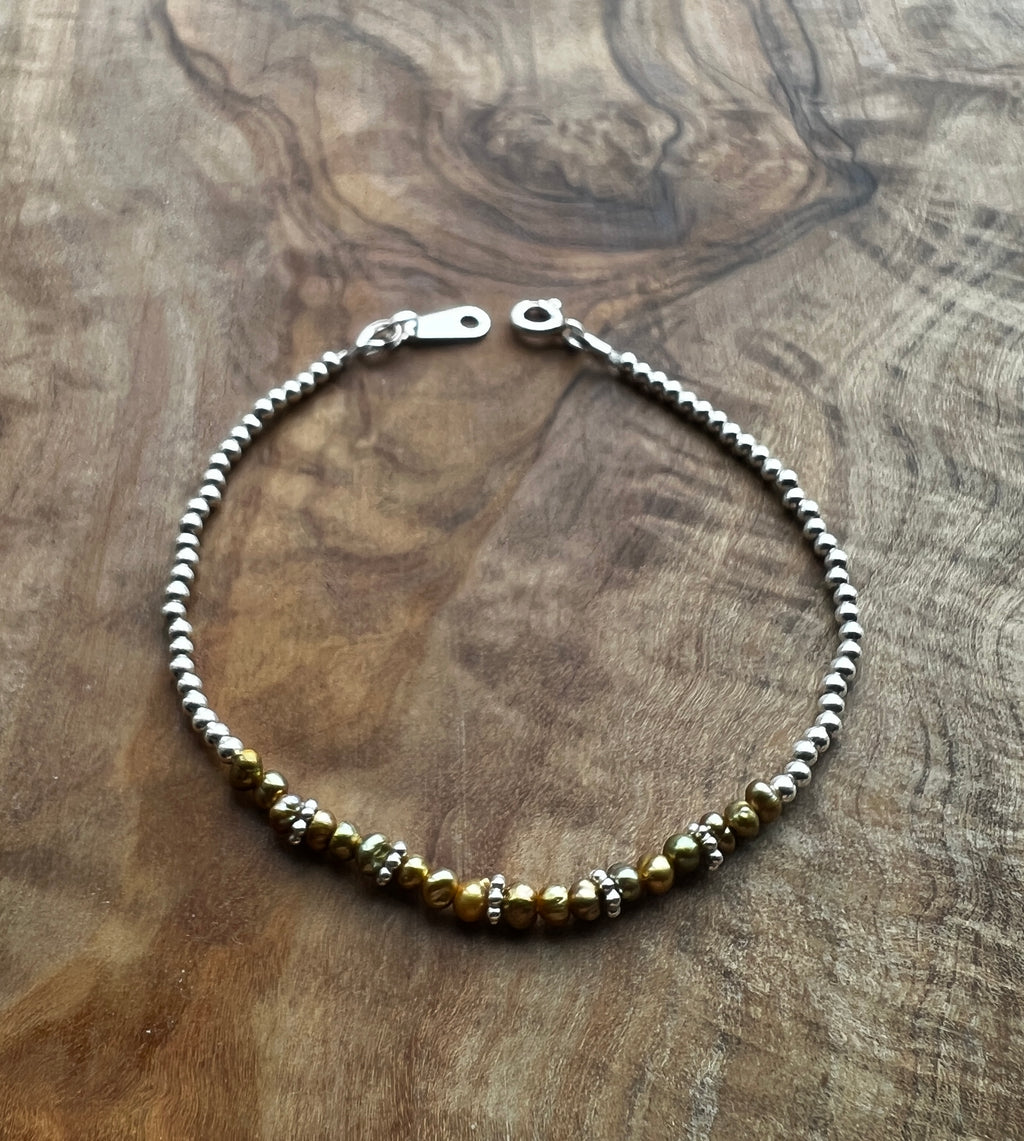 Sterling silver and olive green freshwater pearl bracelet.