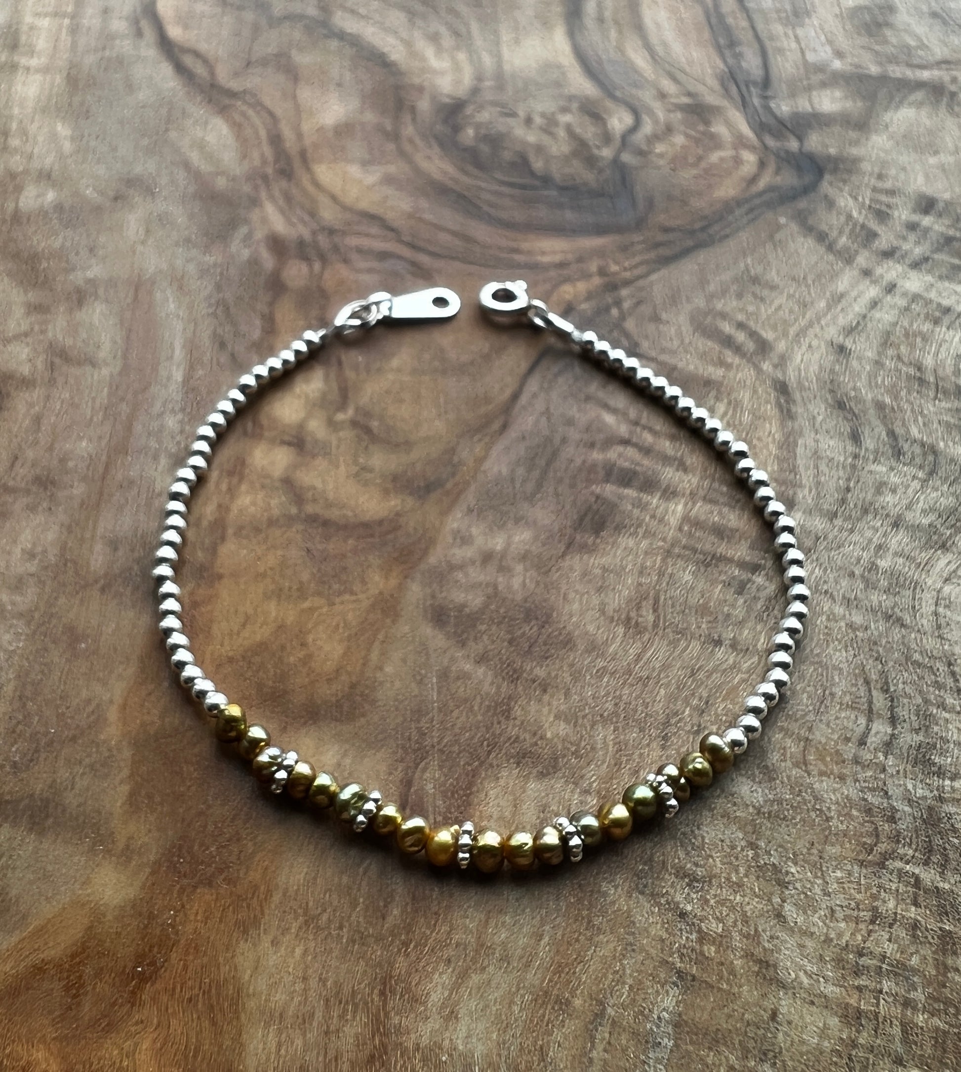 Sterling silver and olive green freshwater pearl bracelet.