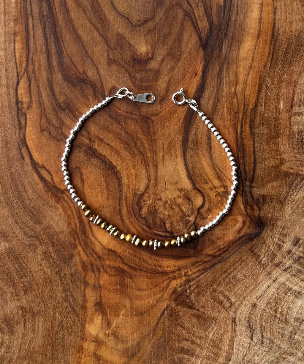 Sterling silver and olive green freshwater pearl bracelet.