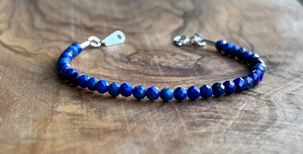 Blue lapis lazuli faceted gemstone with sterling silver bracelet