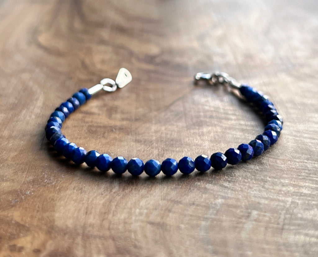 Blue lapis lazuli faceted gemstone with sterling silver bracelet