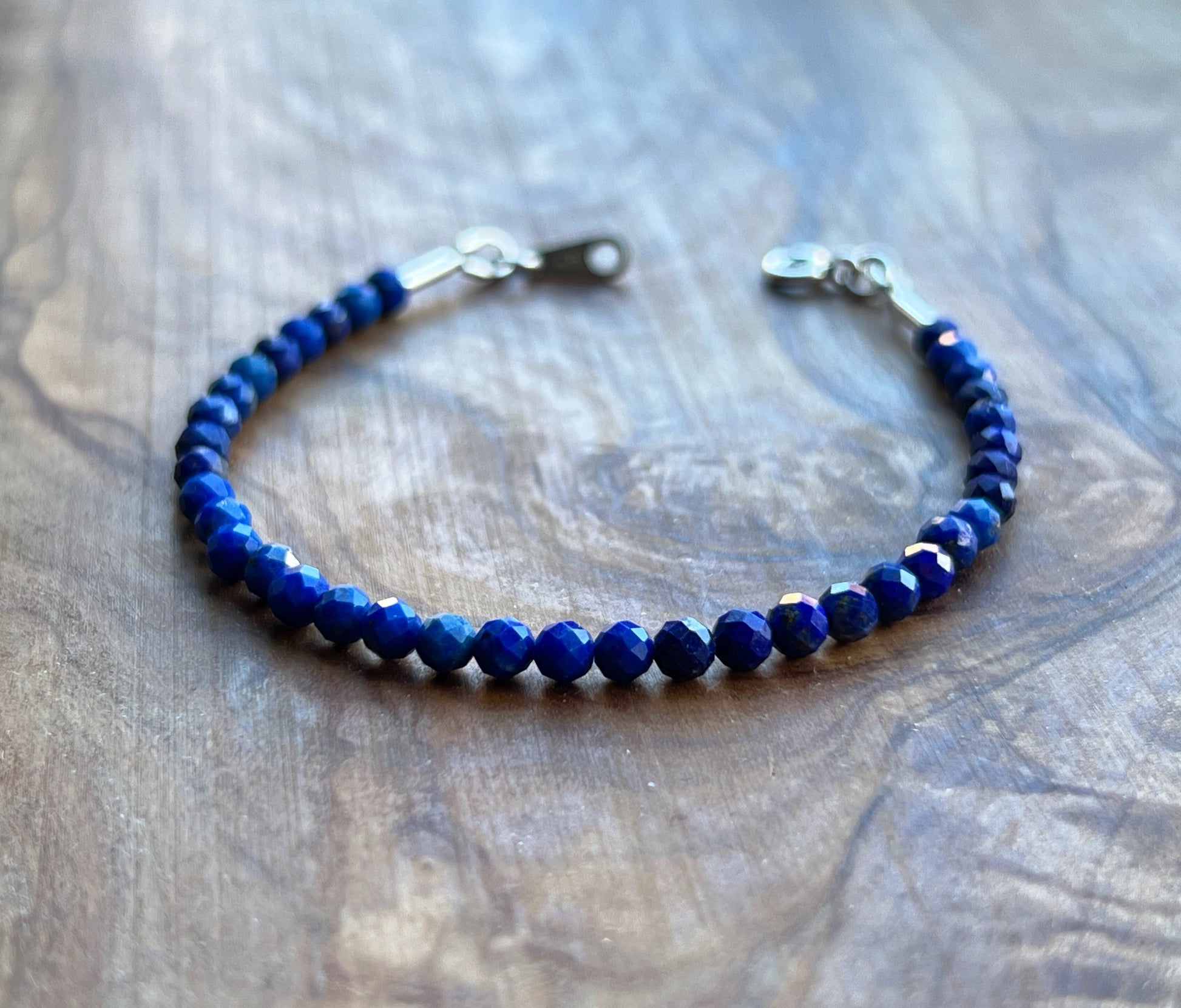 Blue lapis lazuli faceted gemstone with sterling silver bracelet