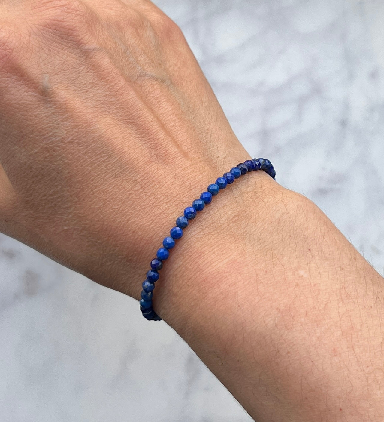 Blue lapis lazuli faceted gemstone with sterling silver bracelet