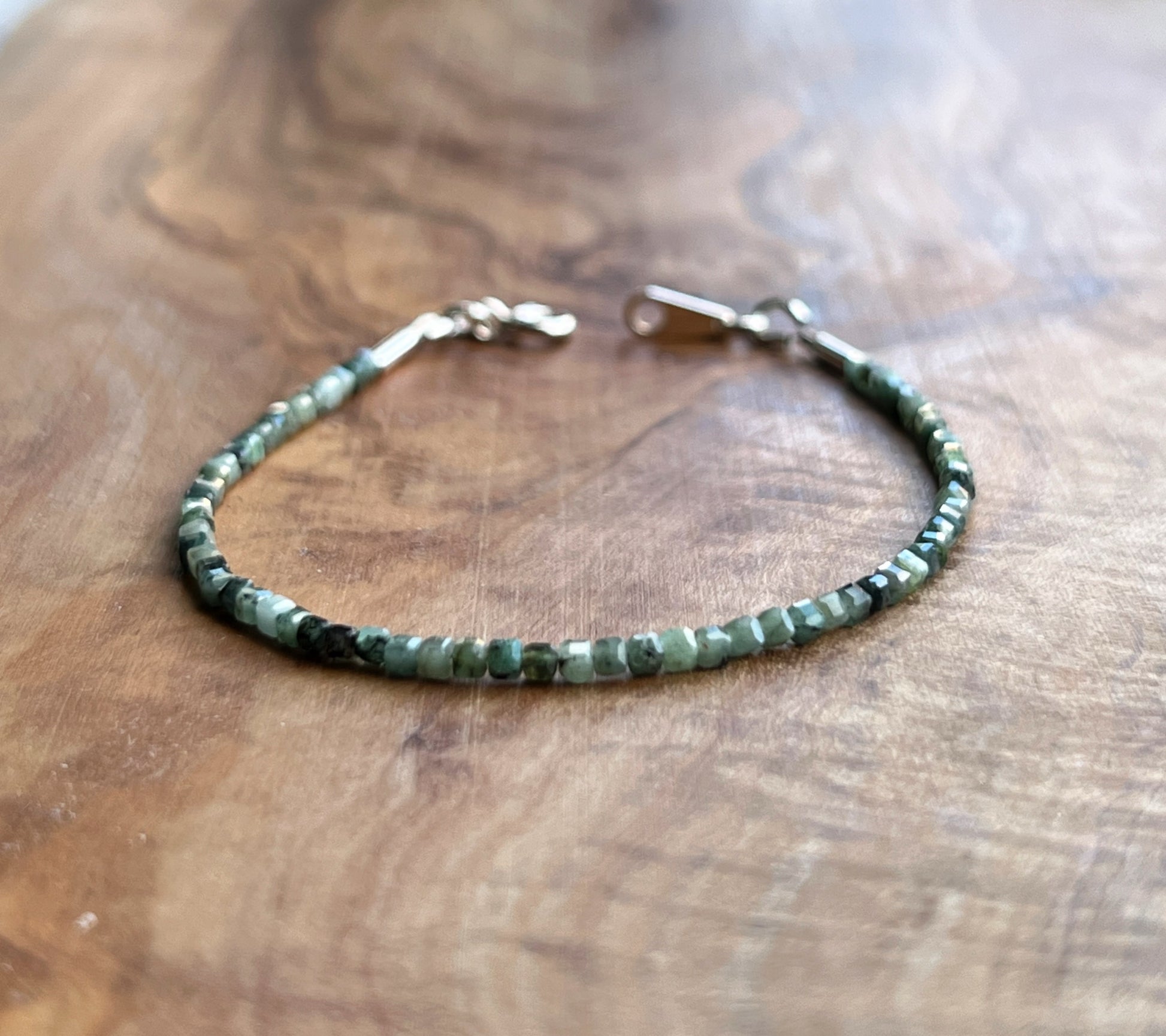 Green emerald gemstone with sterling silver bracelet