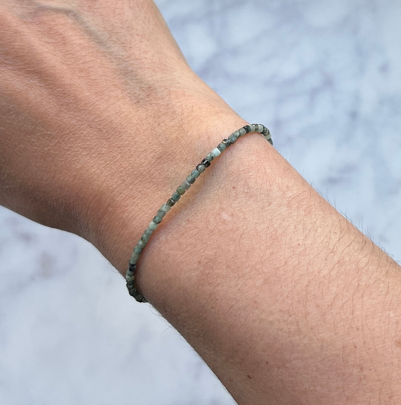 Green emerald gemstone with sterling silver bracelet