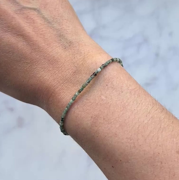 Green emerald gemstone with sterling silver bracelet